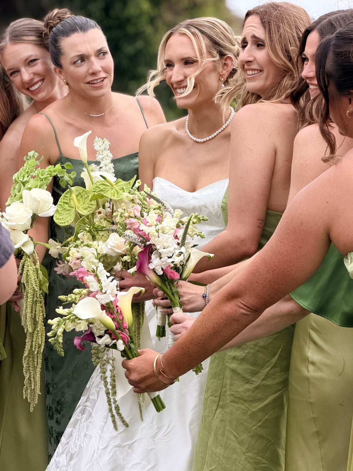 Bride with bridesmaid by the water