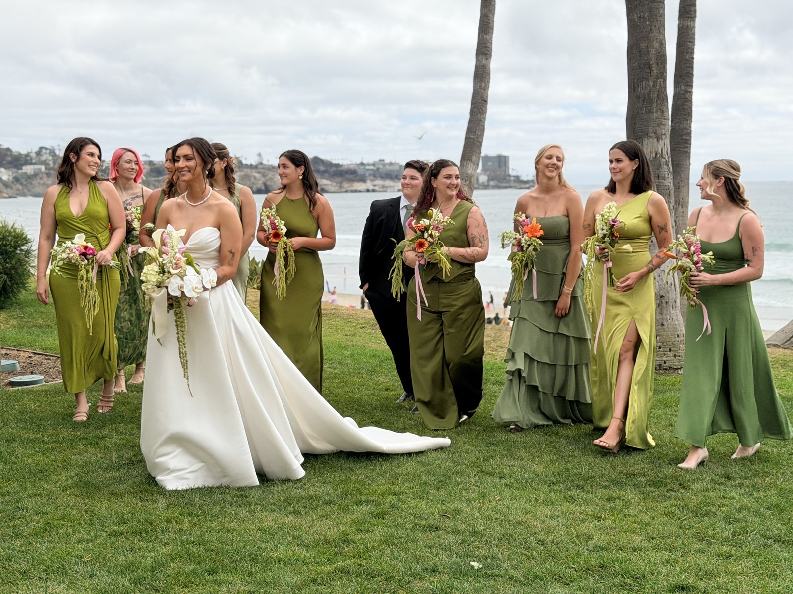 Wedding party walking along the coast