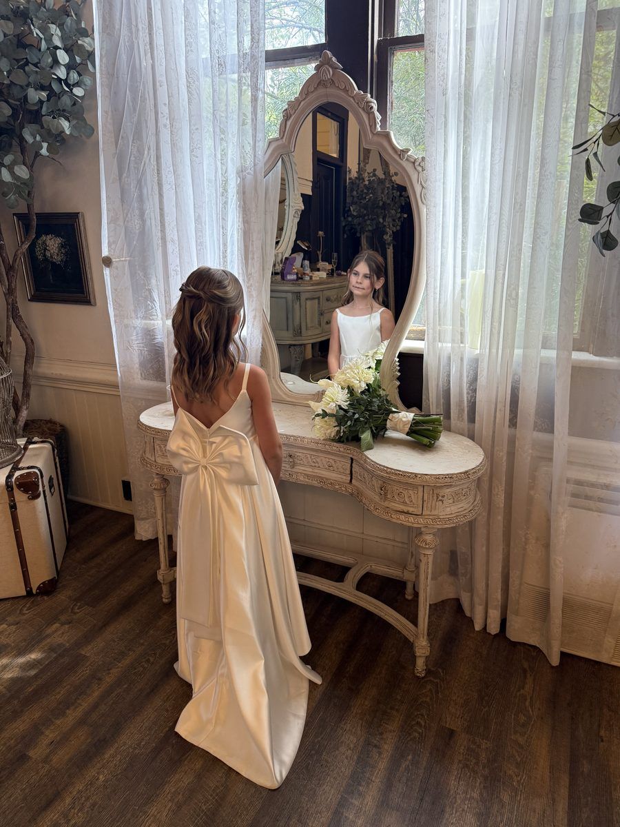Flower girl at mirror