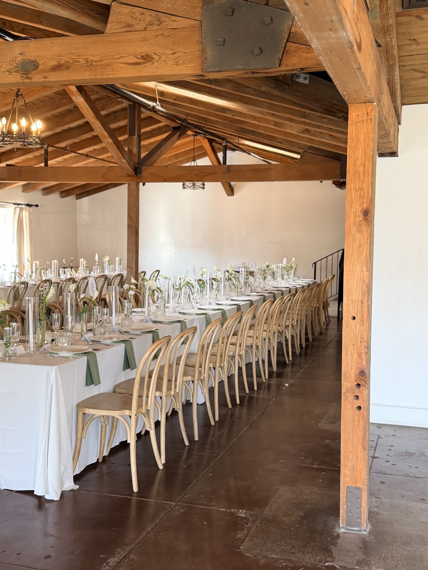 Long reception table under wooden beam ceiling