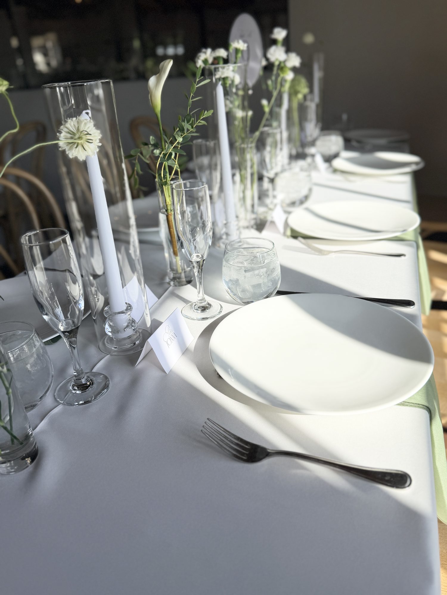 Elegant table setting with candles and white flowers