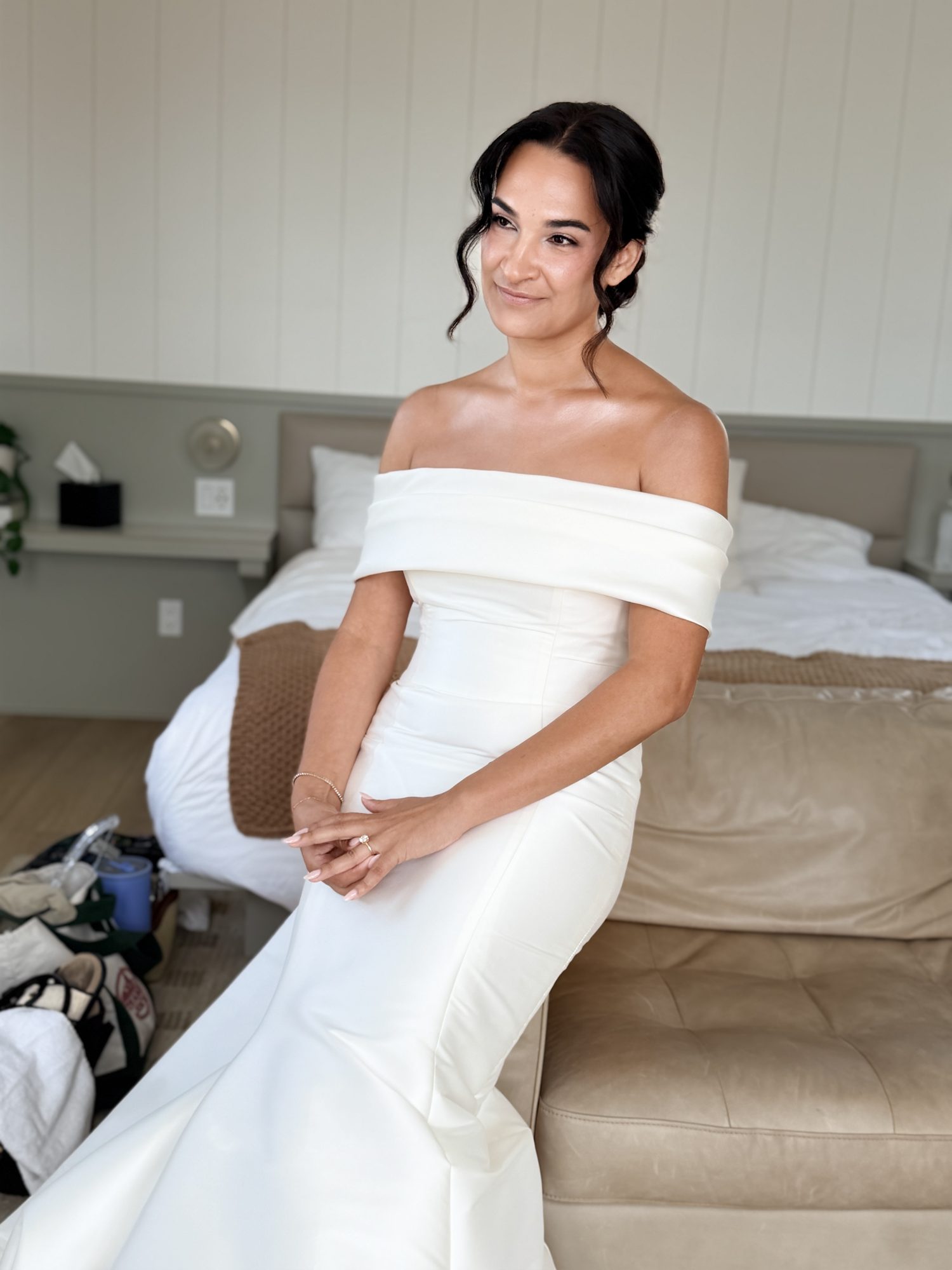 Bride smiling on couch while getting ready