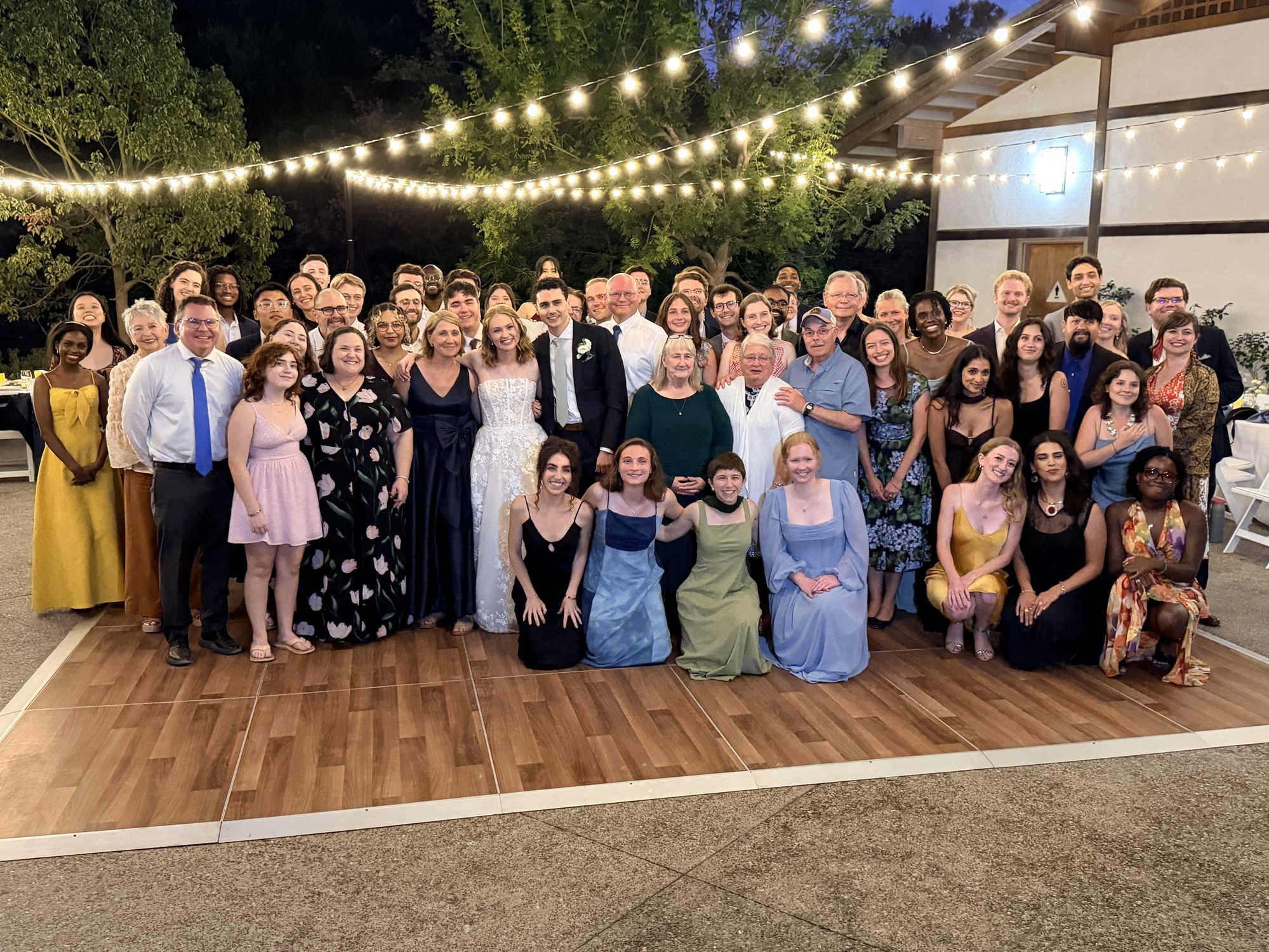 Large wedding party group photo on the dance floor